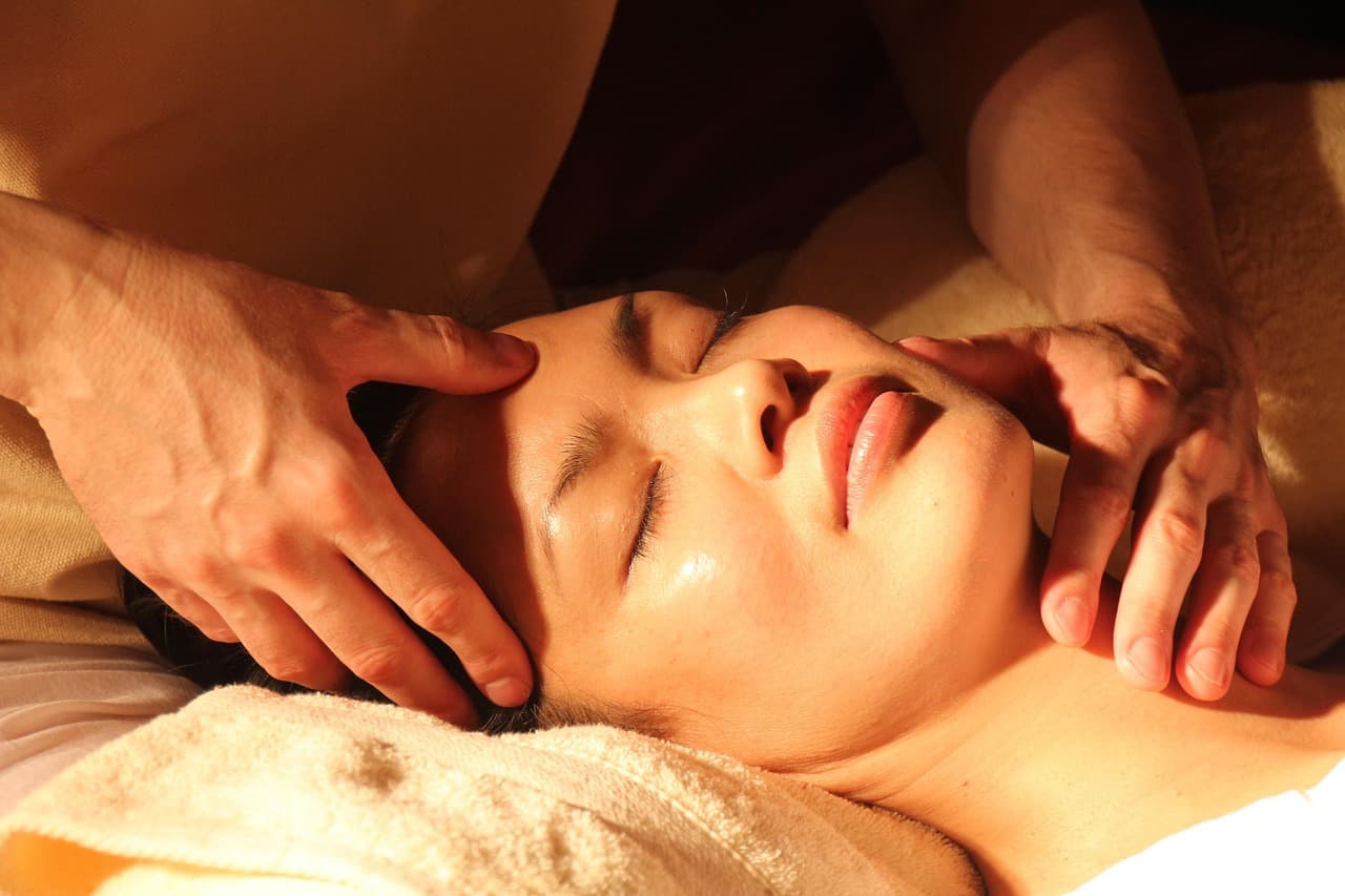 Face and neck massage in warm low light