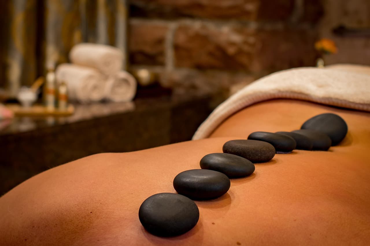 Rolled towels and smooth stones ready for a spa treatment