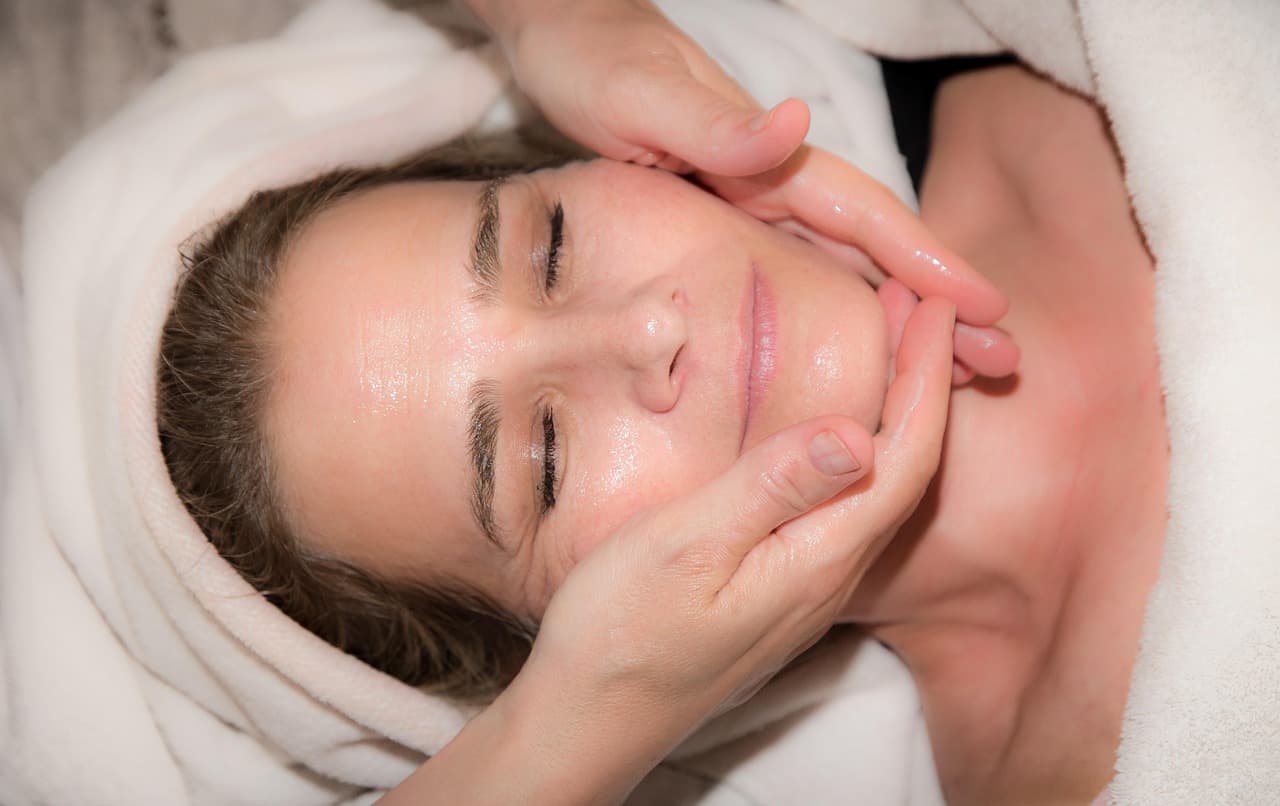 Woman relaxing during a facial massage